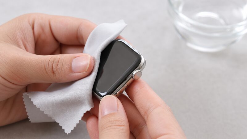 アップルウォッチのステンレスを柔らかな布で手入れする手元